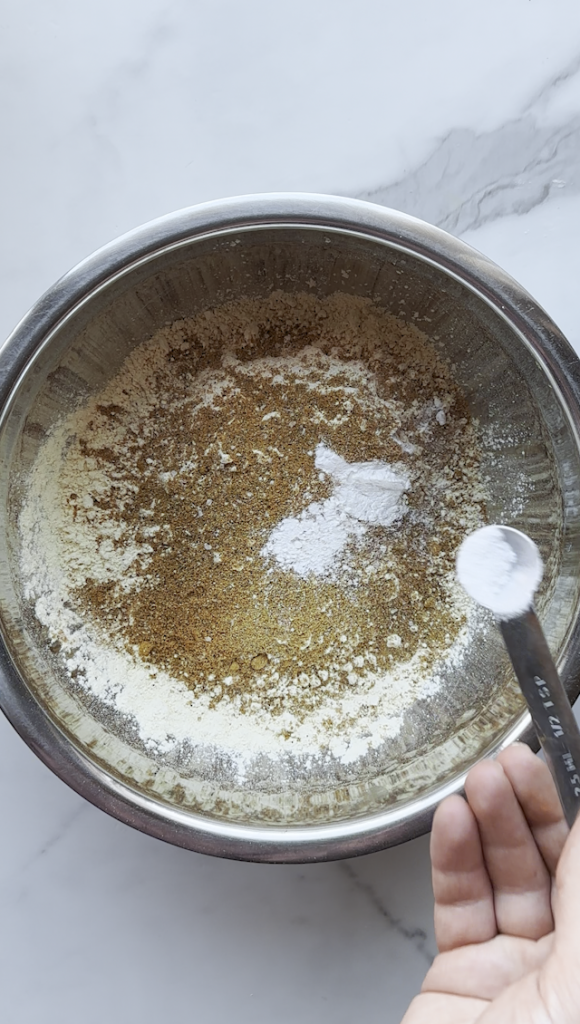 a bowl of chickpea flour, baking powder and seasonings from Ariana Sweets for Afghan Pakawra